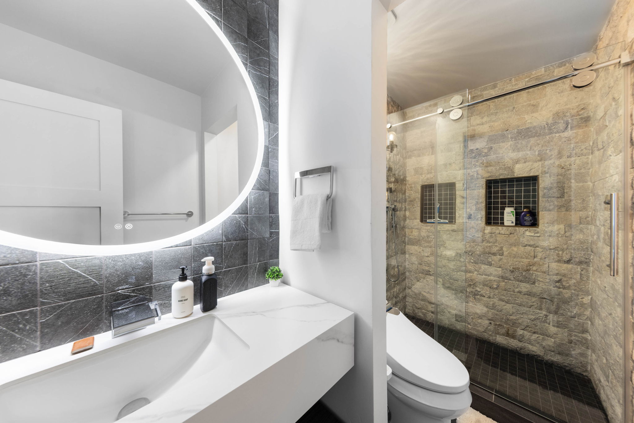 Cubs Manor: backlit mirror and stone shower